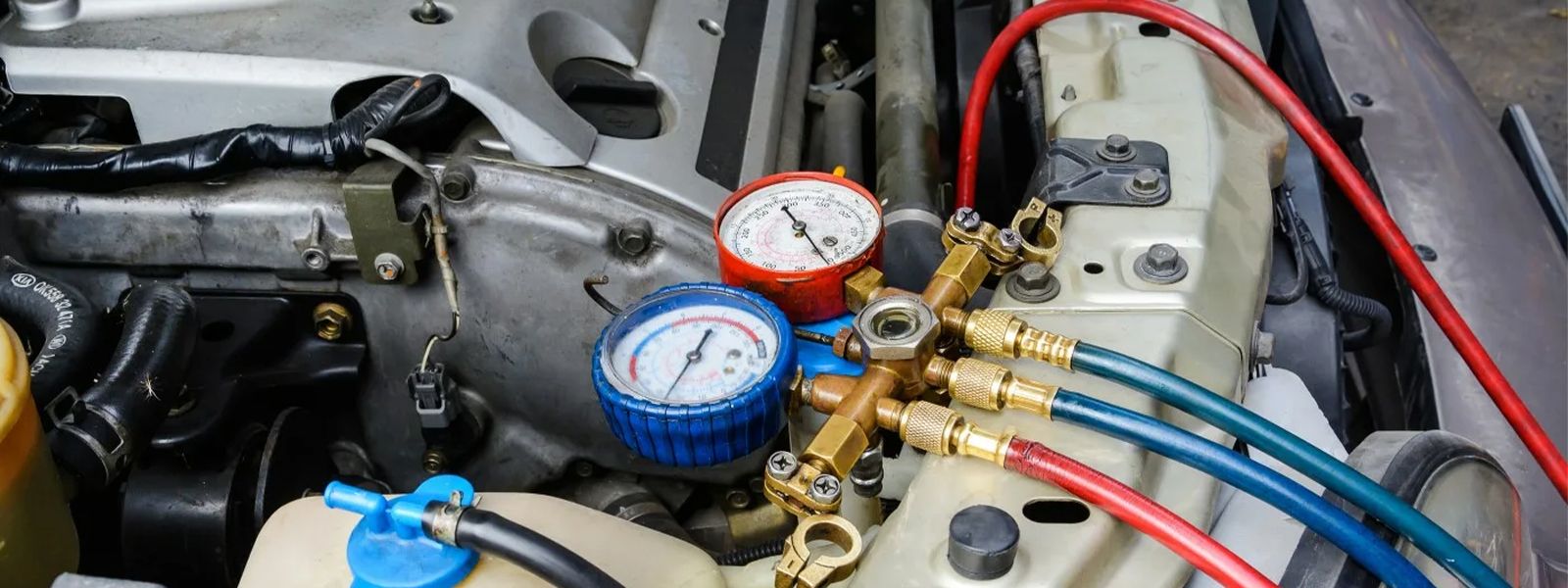 Attach the AC gauge to the low-pressure service port