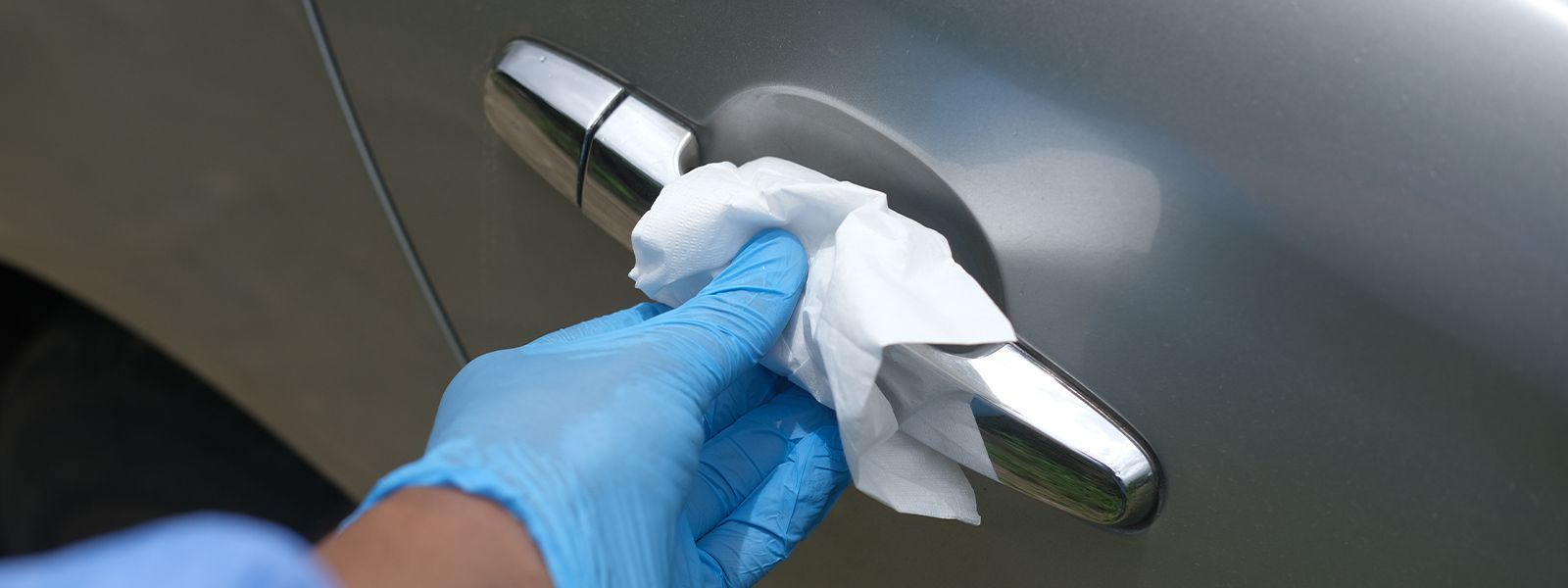 Someone is cleaning the outside door handle.